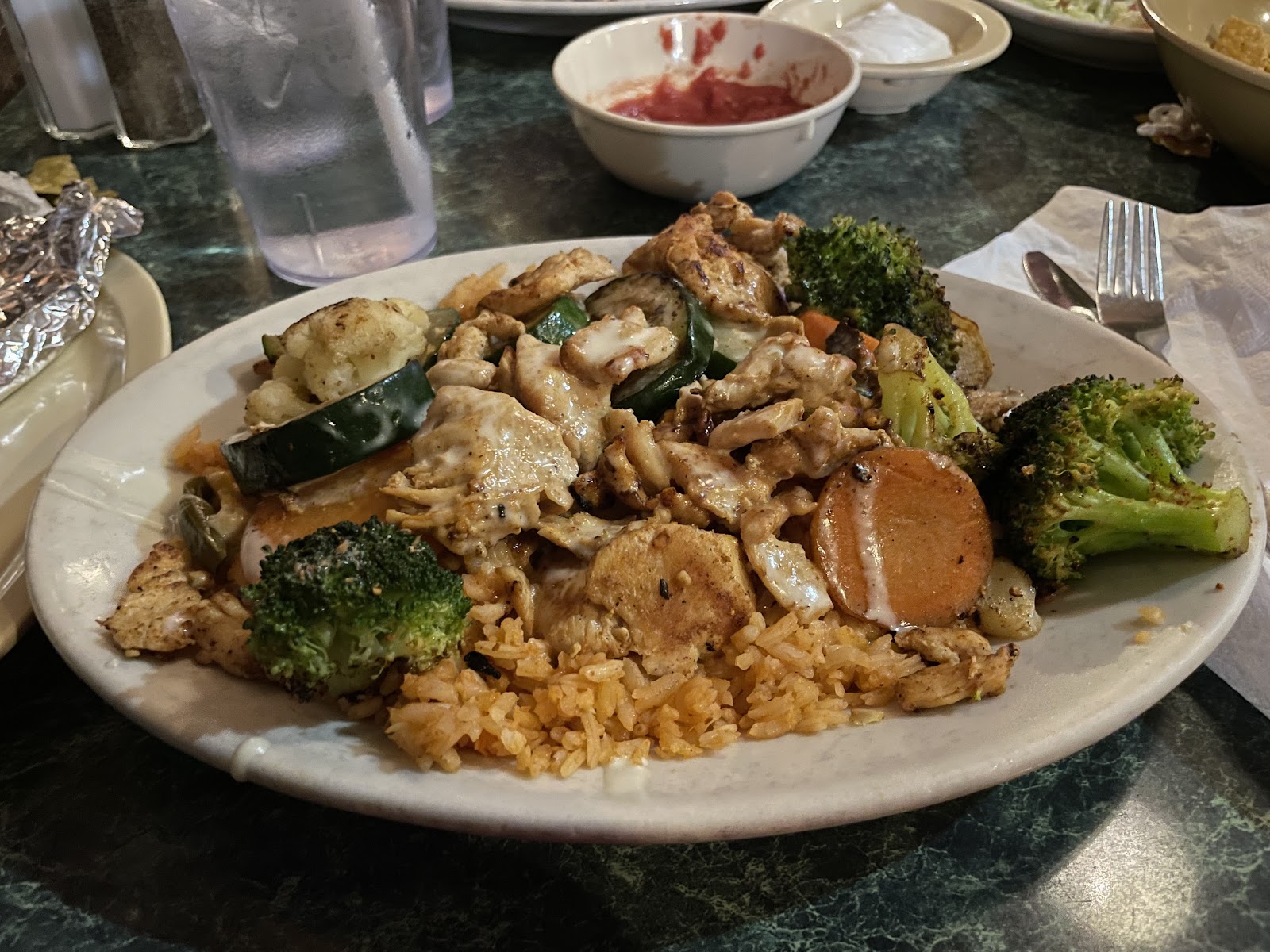 Grilled chicken with vegetables over Mexican rice