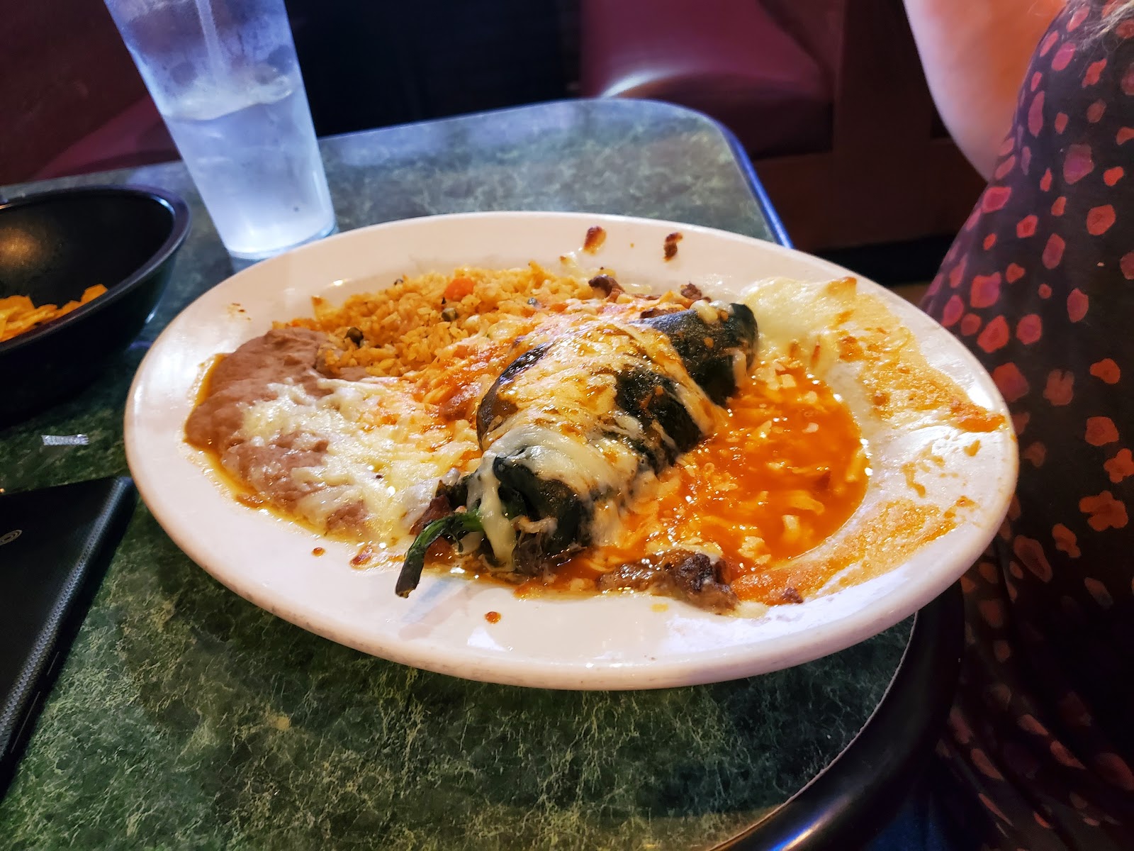 A stuffed poblano chile relleno with rice and refried beans